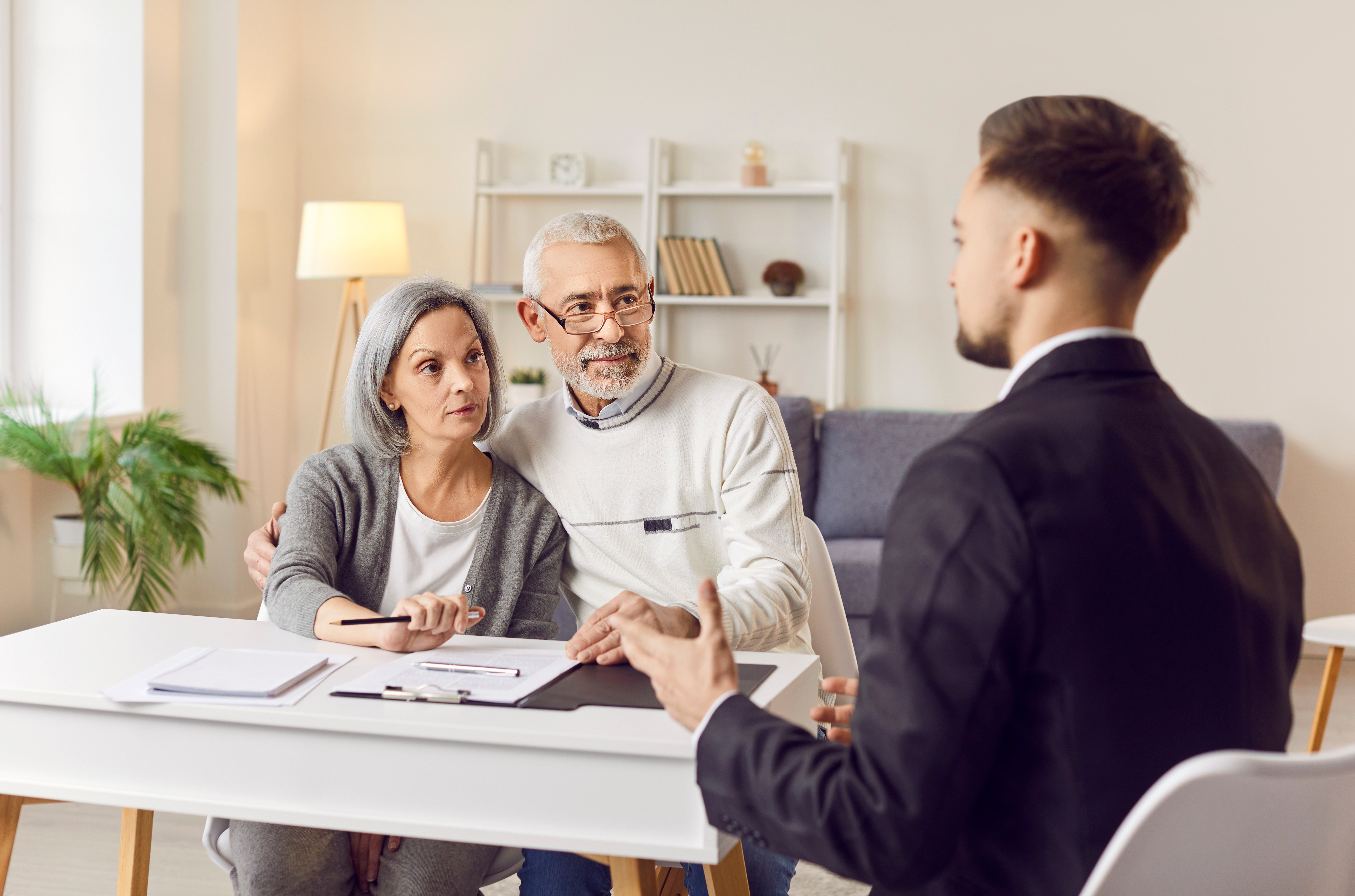 Elderly couple discusses Maryland elder law with an attorney.